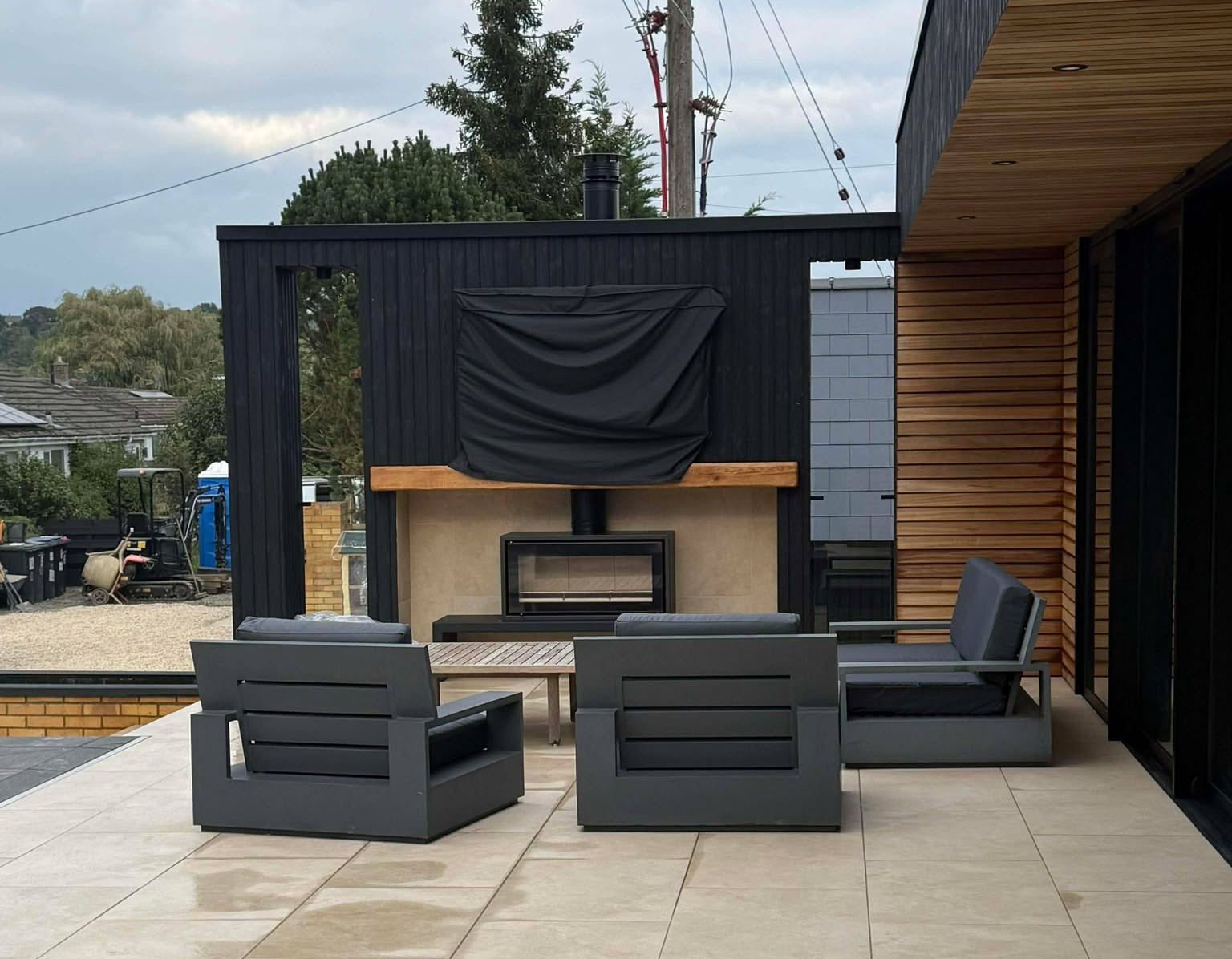 External Media Wall With Built-In Fireplace & Contemporary Timber Detailing